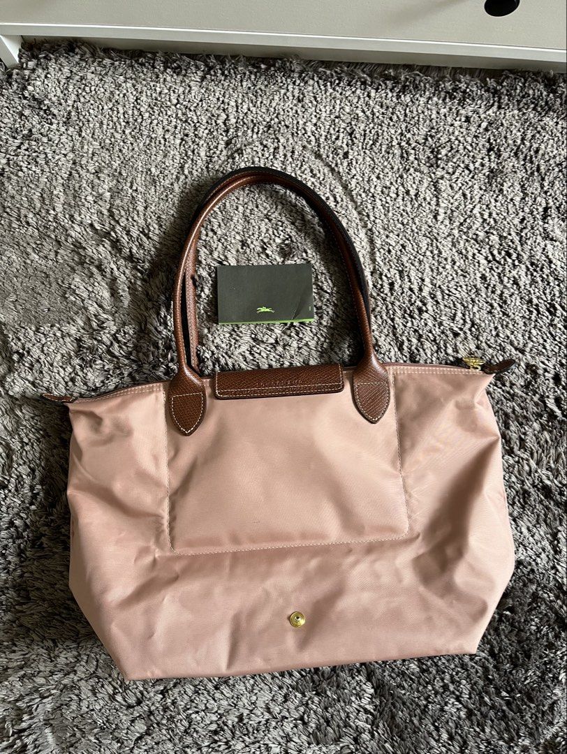 Longchamp Le Pliage Tote Bag (Category: Luxury Bags & Wallets) located in Quezon City. Submitted by jergaragesale (Listing ID 1432814572, Image 2). Description: original longchamp lightly used bought this for 10k+ at rustans color: pink issue: pen mark only.