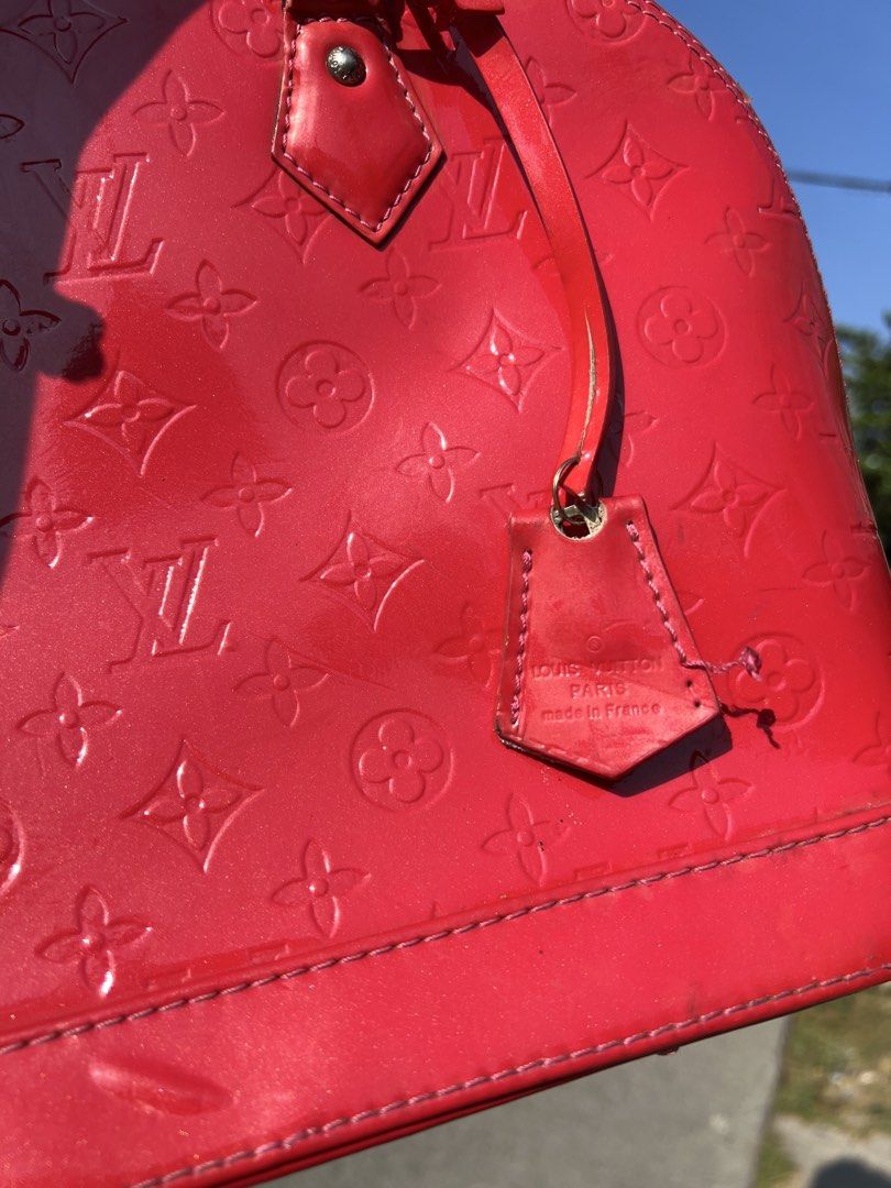 Louis Vuitton Alma BB Red (Category: Luxury Bags & Wallets) located in Manila. Submitted by vastriver-12e2c3 (Listing ID 1432872963, Image 2). Description: - Authentic Louis Vuitton Alma BB - Red patent leather - Iconic LV monogram pattern - Top handle and detachable strap - Pink fabric interior with pocket - Zipper closure - Metal feet - Made in France.