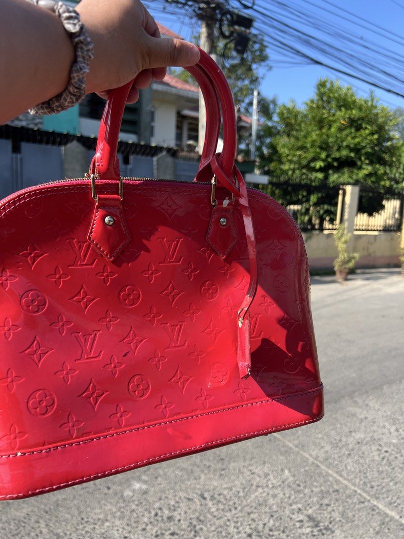 Louis Vuitton Alma BB Red (Category: Luxury Bags & Wallets) located in Manila. Submitted by vastriver-12e2c3 (Listing ID 1432872963, Image 1). Description: - Authentic Louis Vuitton Alma BB - Red patent leather - Iconic LV monogram pattern - Top handle and detachable strap - Pink fabric interior with pocket - Zipper closure - Metal feet - Made in France.