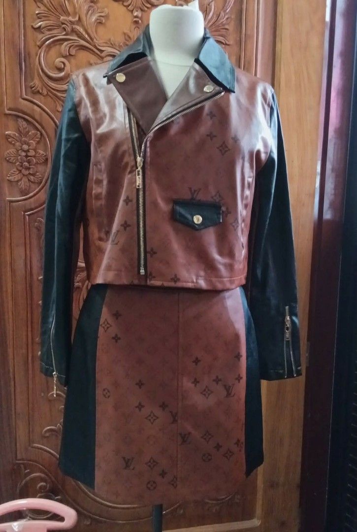 Louis Vuitton Brown Leather Jacket and Skirt Set (Category: Luxury Apparel) located in Cabanatuan. Submitted by almaespino24263 (Listing ID 1432911656, Image 1). Description: - Two-piece outfit: brown leather jacket and skirt - Jacket: biker style, zipper closure, black sleeves, small pocket design, Louis Vuitton logo, gold hardware - Skirt: matching design, black panels, Louis Vuitton logo - Gold hardware on both pieces 3 items sold - 1 left ava