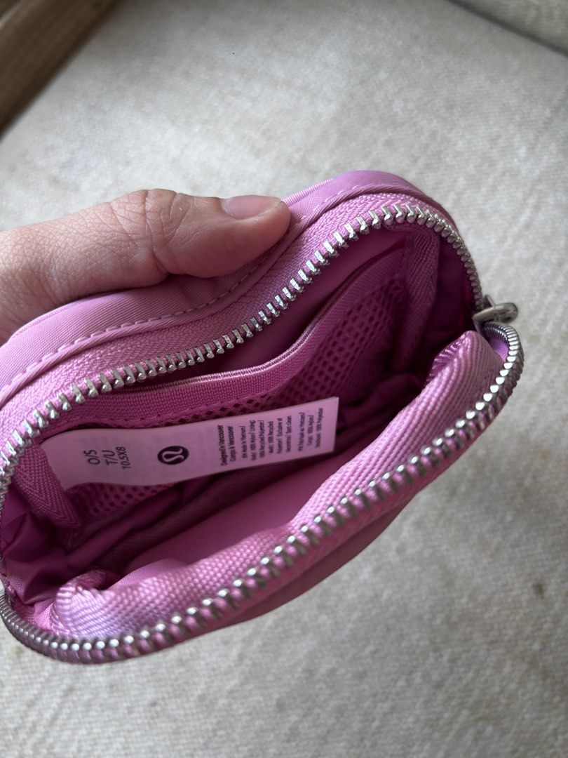Lululemon Everywhere Belt Bag Nano (Category: Cross-body Bags) located in Taguig. Submitted by anik.ph (Listing ID 1432861496, Image 3). Description: - Original, bought this in Japan - Lululemon Everywhere Belt Bag Nano - Pink color - Compact and stylish design - Zippered closure - Small strap on the back - Silver-tone ring - Features the Lululemon logo.