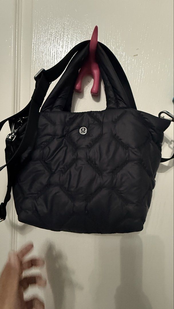 Lululemon Quilted Tote Bag (Category: Tote Bags) located in Navotas City. Submitted by simplifylife01 (Listing ID 1432967414, Image 1). Description: - Lululemon black quilted tote bag - Top handle and detachable shoulder strap - Secure zipper closure - Features the Lululemon logo - Includes a small back pocket.