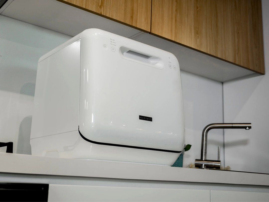 Maximus MAX-004M Mini Dishwasher (Category: Dishwasher) located in Makati City. Submitted by disrepair (Listing ID 1432808546, Image 1). Description: - Maximus portable dishwasher - Sleek white design - Top control panel - Pull-down door - Includes rack for dishes, cups, and cutlery - Countertop-friendly - Ideal for small kitchens and apartments ISSUE: Have not tested in a while and might need repairs.