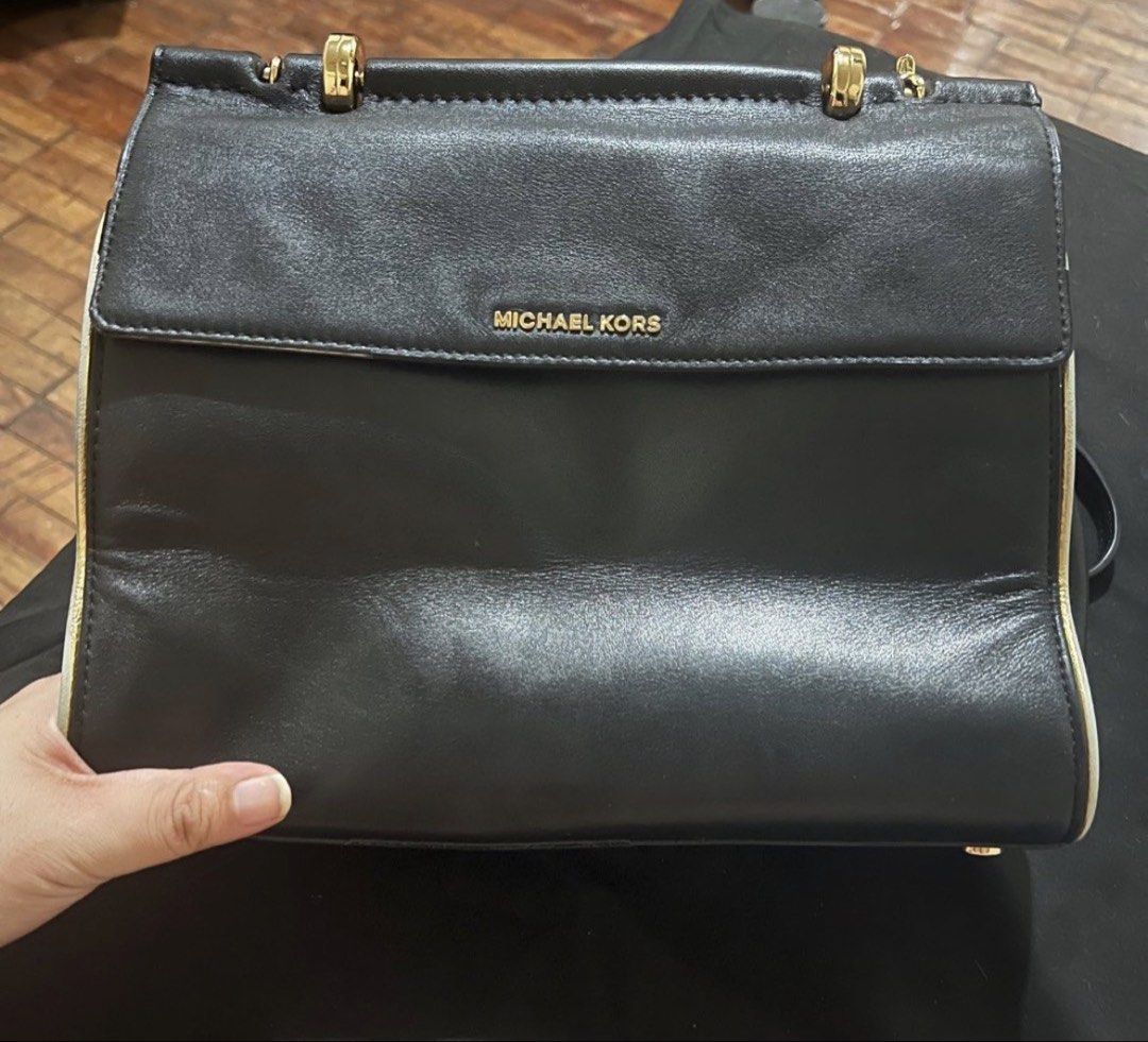 Michael Kors Black Jasmine Handbag (Category: Luxury Bags & Wallets) located in Manila. Submitted by kiersten2792 (Listing ID 1432923680, Image 1). Description: - Black Michael Kors handbag - Gold-tone hardware - Top handle and flap closure - Rectangular shape with contrasting trim - Includes a shoulder strap - Features the Michael Kors logo —Lining needs to be replaced but overall the bag is usable and in good condition Negotiable!!! But no lowb