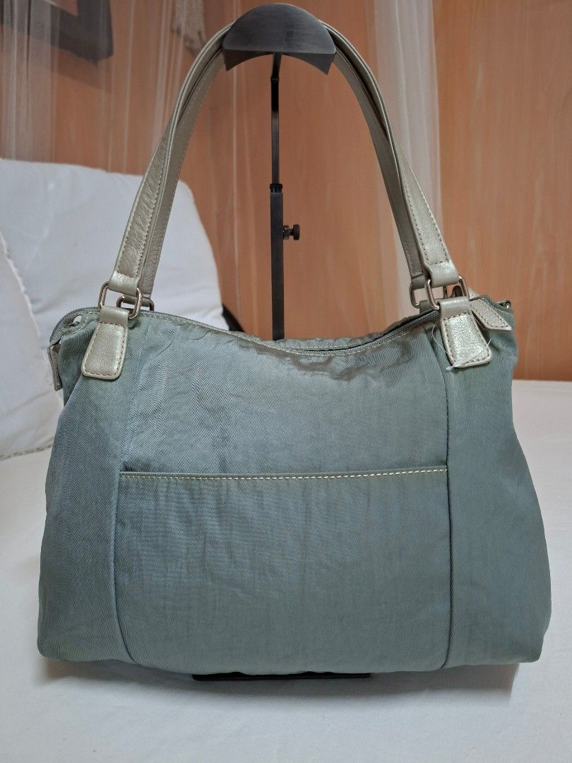 Mila Schon Shoulder Bag (Category: Shoulder Bags) located in Pasay City. Submitted by onick_79 (Listing ID 1432964152, Image 3). Description: - Mila Schon shoulder bag - Elegant blue-grey color - Front pocket for easy access - Spacious interior with multiple compartments - Comfortable shoulder strap - Secure zip closure - Interior pocket with brand label - Stylish silver metallic handles Mila Schön shoulder bag, an Italian luxury brand known for 
