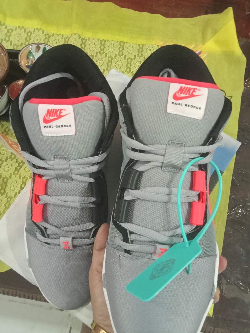 Nike Paul George PG 3 Sneakers (Category: Sneakers) located in Caloocan City. Submitted by parc. (Listing ID 1432938373, Image 2). Description: - Nike Paul George PG 3 sneakers - Color: Gray, red, and black - Features Nike logo - Includes original box and green tag - Gray laces, white sole with red accents - Unworn condition.