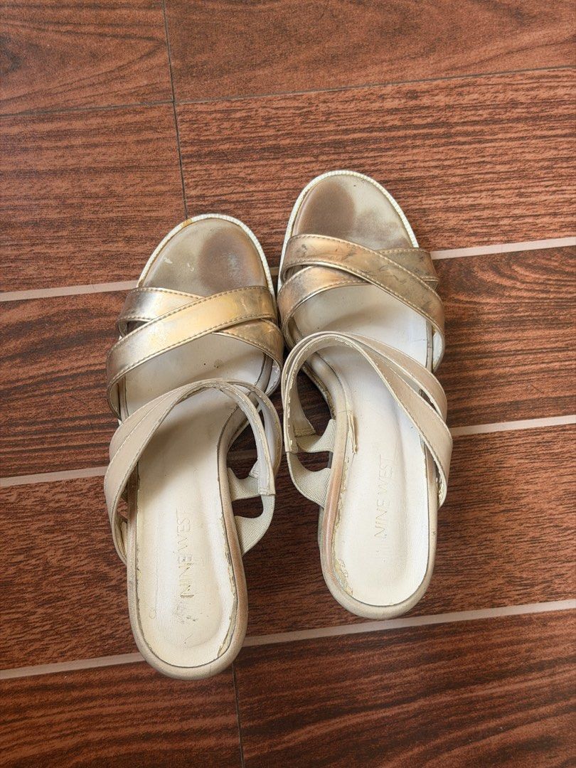 Nine West Gold Wedge Sandals (Category: Wedges) located in Cavite. Submitted by peppermintsss (Listing ID 1432794050, Image 1). Description: - Nine West wedge sandals - Gold color - Criss-cross strap design - Slip-on style - Cork-like sole - Wedge heel ‼️Shows wear on footbed and sole.