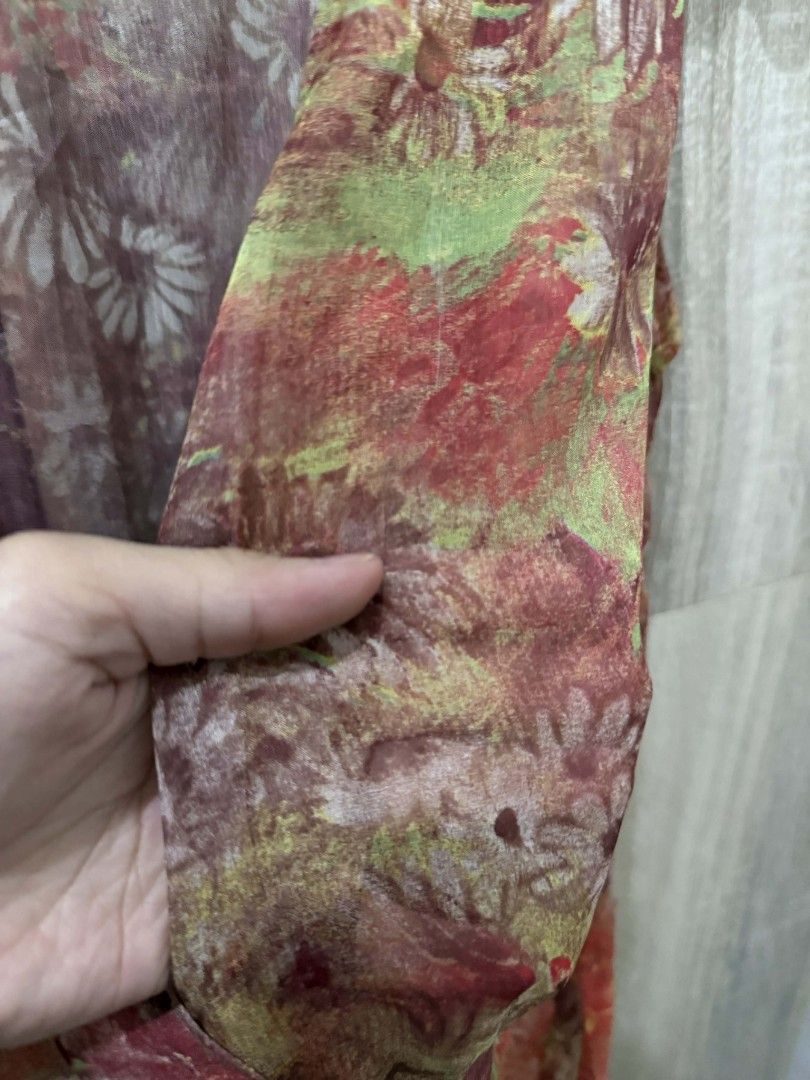NY Floral Sleeveless Top (Category: Sleeveless) located in Cavite. Submitted by ahlecz13 (Listing ID 1432952958, Image 3). Description: - Sleeveless floral top - V-neck design - Wrap-style front - Waist tie - Colorful floral pattern (red, green, white) - Lightweight, semi-sheer fabric.
