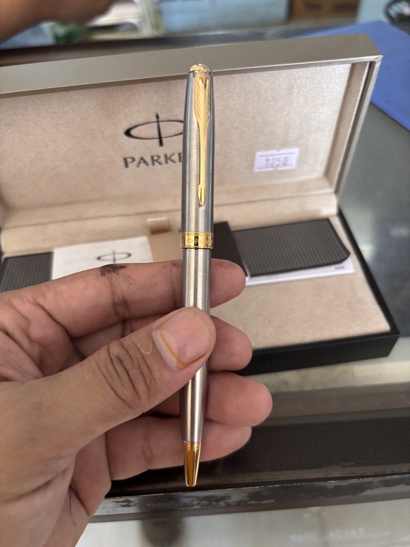 Parker Pen with Box (Category: Stationery & School Supplies) located in Victoria. Submitted by eliphalez (Listing ID 1432855774, Image 1). Description: - Parker pen with original box and paperwork - Silver body with gold accents - Perfect gift or collector's item Issue no ink.
