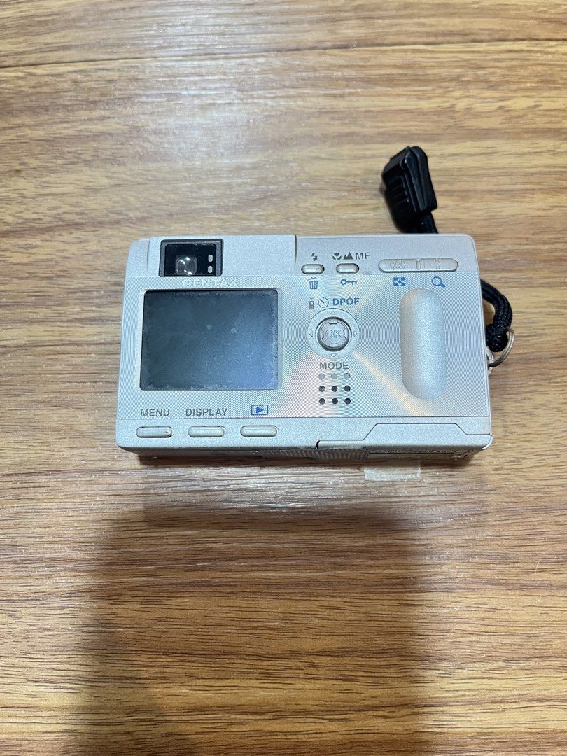 Pentax Optio S Digital Camera (Category: Cameras) located in Quezon City. Submitted by manilathrifter (Listing ID 1432910368, Image 2). Description: - Pentax Optio S digital camera - 3x optical zoom lens - Silver color - Includes wrist strap - Display screen and function buttons -working camera -includes camera and battery only -no sd card -no charger issue: broken battery door taped only 2,900 plus sf pasig.