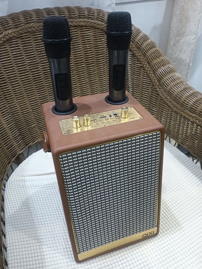 Portable Karaoke Speaker with Microphones (Category: Soundbars, Speakers & Amplifiers) located in Quezon City. Submitted by dizeshop (Listing ID 1432810273, Image 1). Description: - Portable karaoke speaker - Includes two microphones - Features control knobs for volume and settings - Stylish brown leather-like exterior - Gold-colored control panel and accents - Built-in speaker - Microphone slots declutter/moving out location: flora vista Quezon 