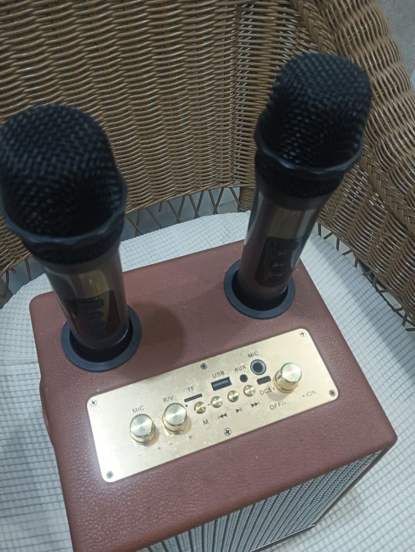 Portable Karaoke Speaker with Microphones (Category: Soundbars, Speakers & Amplifiers) located in Quezon City. Submitted by dizeshop (Listing ID 1432810273, Image 2). Description: - Portable karaoke speaker - Includes two microphones - Features control knobs for volume and settings - Stylish brown leather-like exterior - Gold-colored control panel and accents - Built-in speaker - Microphone slots declutter/moving out location: flora vista Quezon 