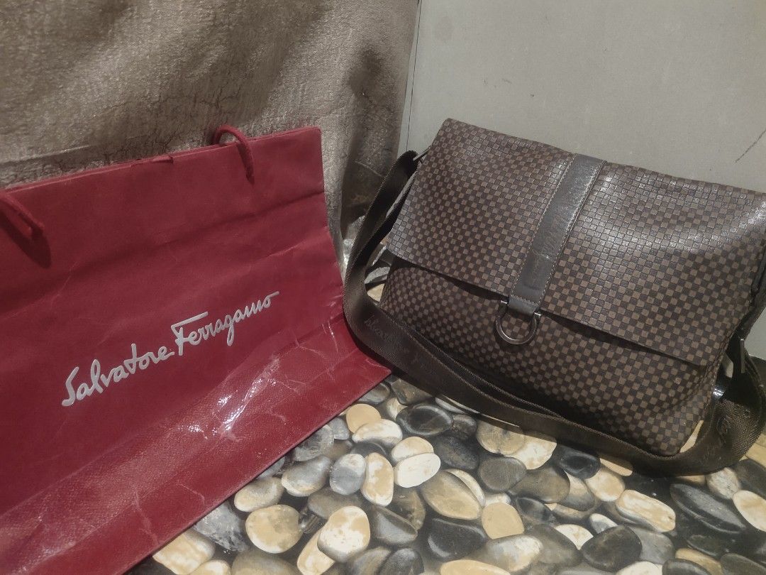 Salvatore Ferragamo Messenger Bag (Category: Luxury Bags & Wallets) located in Cagayan de Oro. Submitted by secretshopph (Listing ID 1432953199, Image 1). Description: - Salvatore Ferragamo messenger bag - Checkered pattern - Flap closure with metal ring detail - Adjustable shoulder strap - Interior zippered compartment -Suede interior.