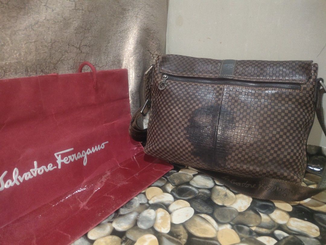 Salvatore Ferragamo Messenger Bag (Category: Luxury Bags & Wallets) located in Cagayan de Oro. Submitted by secretshopph (Listing ID 1432953199, Image 3). Description: - Salvatore Ferragamo messenger bag - Checkered pattern - Flap closure with metal ring detail - Adjustable shoulder strap - Interior zippered compartment -Suede interior.