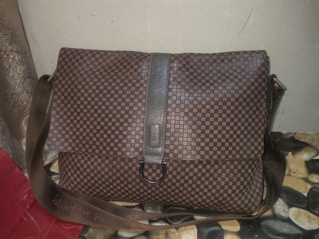 Salvatore Ferragamo Messenger Bag (Category: Luxury Bags & Wallets) located in Cagayan de Oro. Submitted by secretshopph (Listing ID 1432953199, Image 2). Description: - Salvatore Ferragamo messenger bag - Checkered pattern - Flap closure with metal ring detail - Adjustable shoulder strap - Interior zippered compartment -Suede interior.