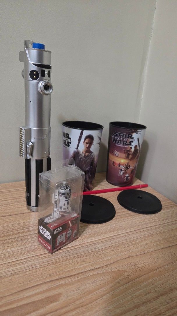 Star Wars Bundle - Lightsaber, R2D2 USB, 2 Large Plastic Cup (Category: Western Merchandise) located in Taguig. Submitted by tinosaur (Listing ID 1432941411, Image 1). Description: - Take All for 550 Includes: - Star Wars Lightsaber: Blue blade, retractable, silver handle. Luke Skywalker - Character Cups: Featuring Star Wars characters and scenes. - R2-D2 USB (1GB) still working. In original packaging. - Accessories: Includes a red straw and two 