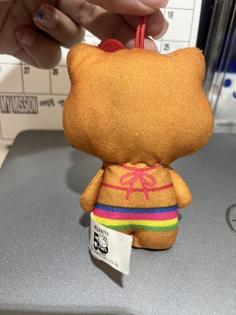 Tan Hello Kitty 50th Anniversary Plush Toy keychain (Category: Character Goods) located in Candelaria. Submitted by wishizen (Listing ID 1432927561, Image 2). Description: - Limited Edition: Kitty 50th Anniversary Plush! - Adorable design: Kitty in a colorful bikini. - Includes: Flower on her head and a convenient hanging string. - Condition: original tag attached. - Perfect for: Kitty collectors and fans!.