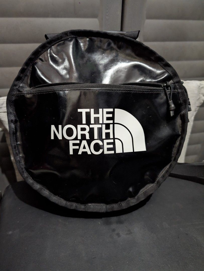 The North Face Backpack (Category: Backpacks) located in Imus. Submitted by kmoort (Listing ID 1432846931, Image 1). Description: - The North Face black backpack - Top handle and adjustable shoulder straps - Front zipper pocket - Small logo on the back - Made of durable, water-resistant material - Care label visible.