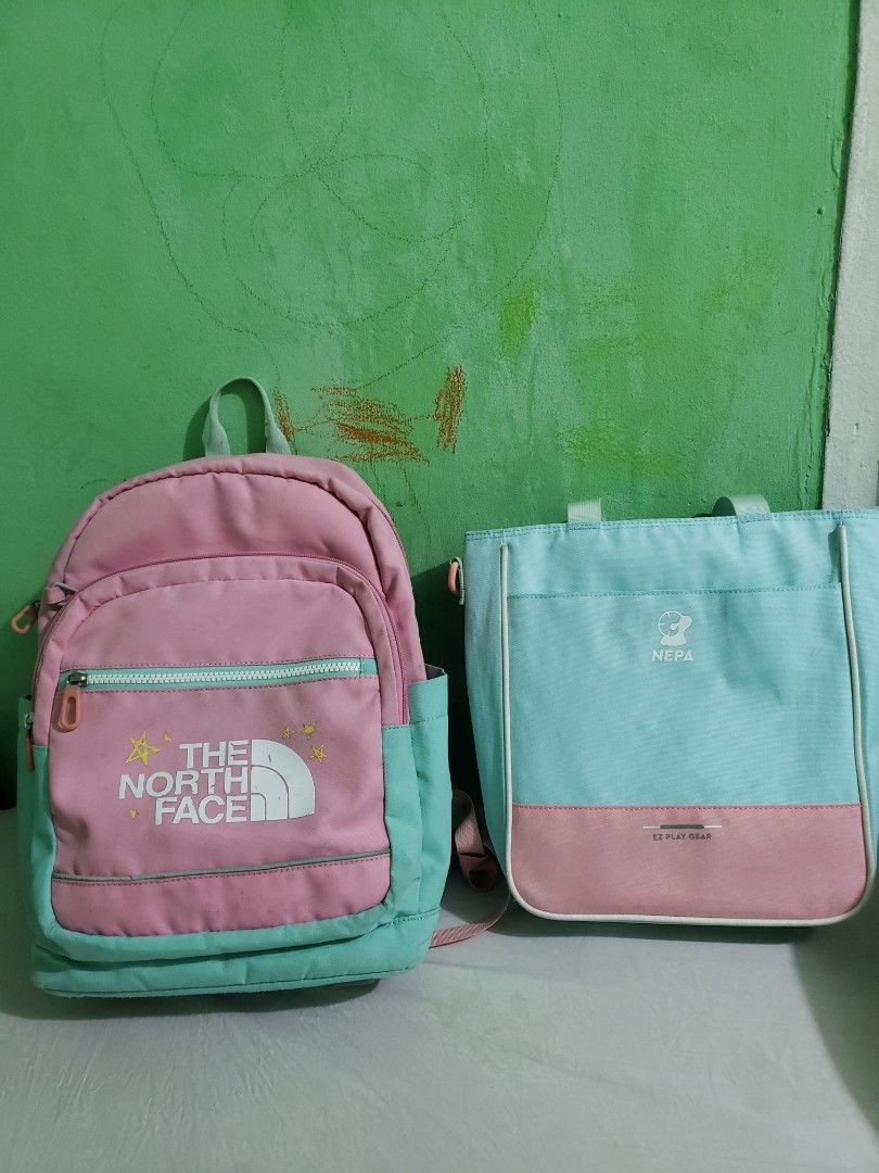 The North Face Backpack and Pouch Set (Category: Backpacks) located in Manila. Submitted by feg39 (Listing ID 1432877405, Image 1). Description: - The North Face backpack and nepa book bag set. - Color: Pink and teal. - Backpack features: - Front zipper pocket - Padded shoulder straps - Interior name tag - Pouch features: - Top handle - Zipper closure best for grade1-2 location pick up MARULAS VALENZUELA .