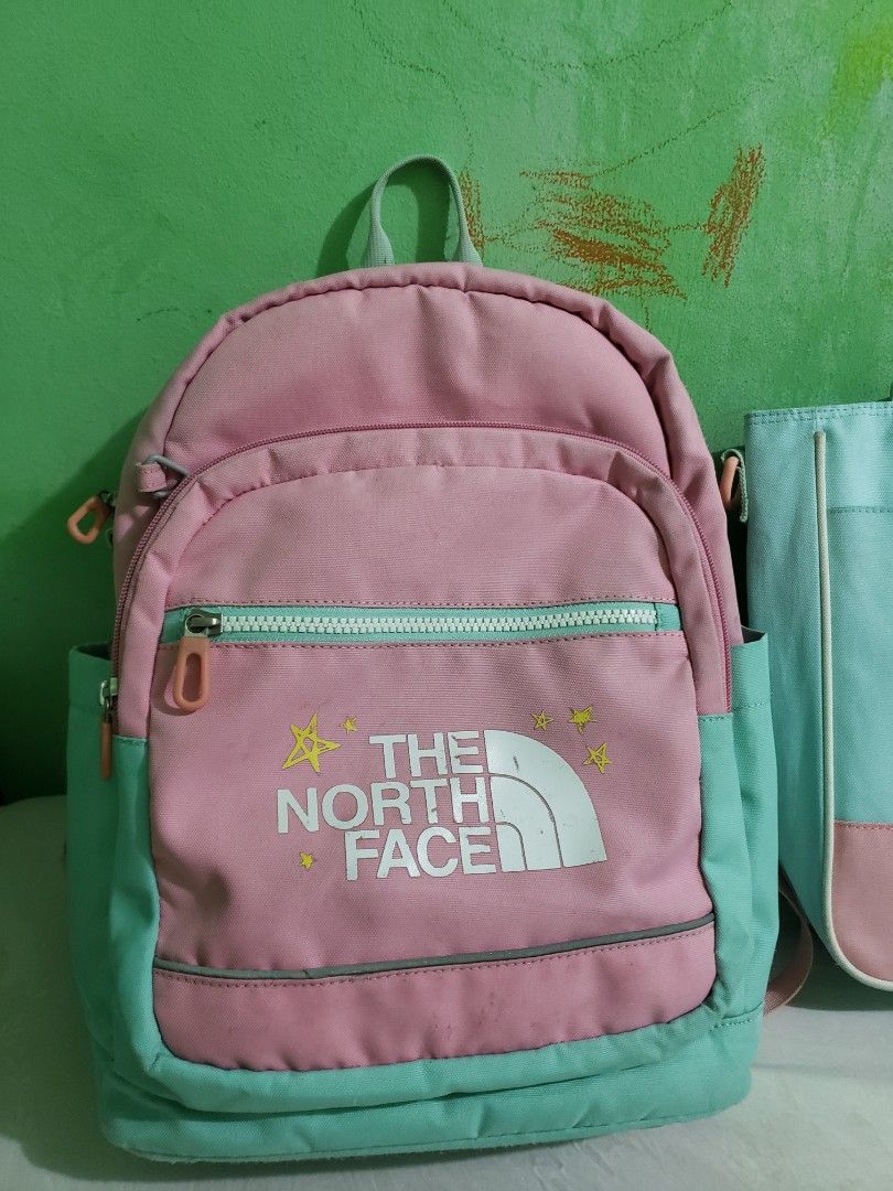The North Face Backpack and Pouch Set (Category: Backpacks) located in Manila. Submitted by feg39 (Listing ID 1432877405, Image 2). Description: - The North Face backpack and nepa book bag set. - Color: Pink and teal. - Backpack features: - Front zipper pocket - Padded shoulder straps - Interior name tag - Pouch features: - Top handle - Zipper closure best for grade1-2 location pick up MARULAS VALENZUELA .
