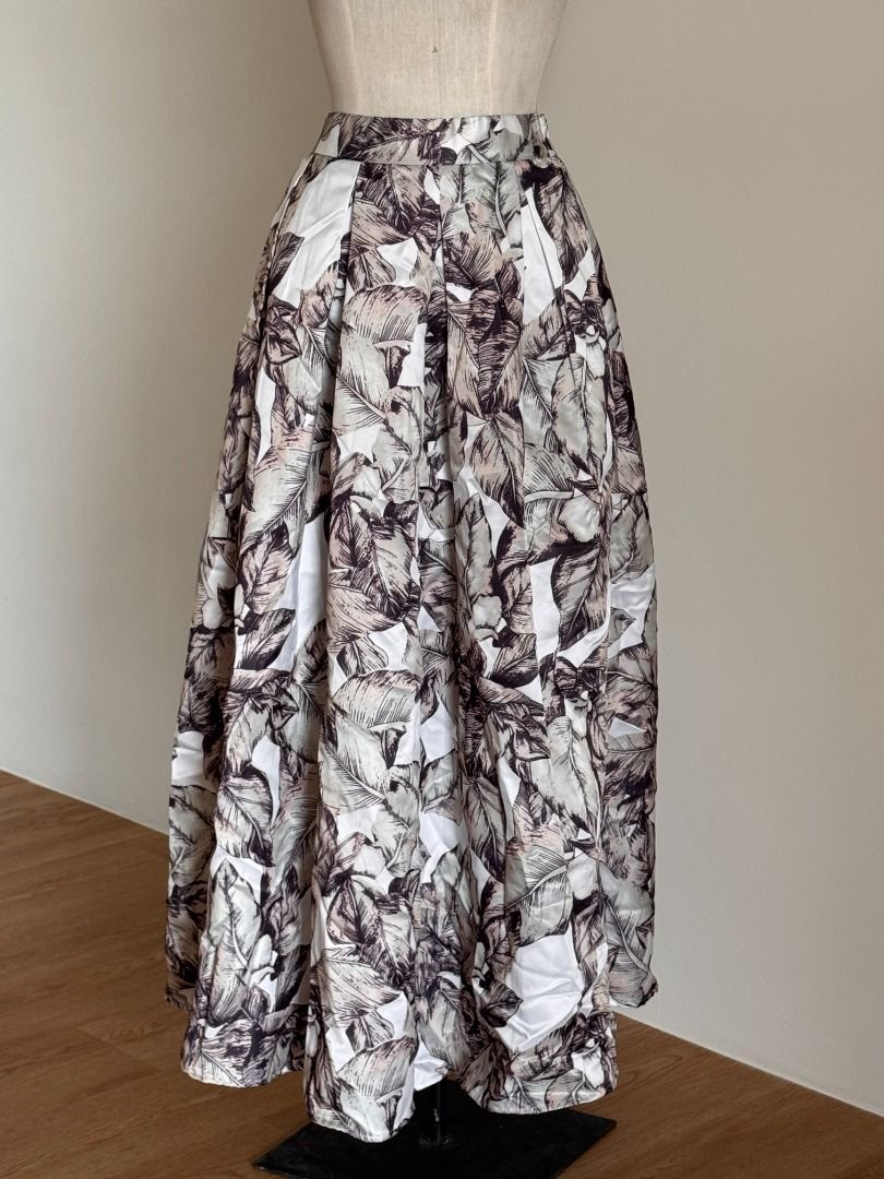 Tropical Leaf Satin Maxi Skirt (Category: Skirts) located in Botolan. Submitted by kstyled (Listing ID 1432859759, Image 2). Description: Elegant Tropical Leaf Satin Maxi Skirt Origin: Boutique find from Thailand Style: High-waisted A-line maxi skirt with a dramatic, voluminous silhouette. Garterized back for a comfier fit. Pattern: Neutral tropical leaf print in shades of mocha, charcoal, pale sage, and cream. Fabric: Premium satin-finish materi