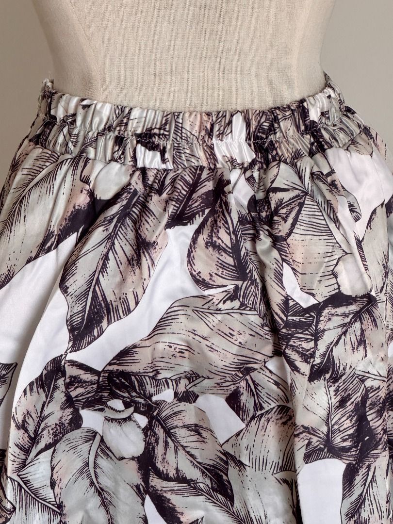 Tropical Leaf Satin Maxi Skirt (Category: Skirts) located in Botolan. Submitted by kstyled (Listing ID 1432859759, Image 3). Description: Elegant Tropical Leaf Satin Maxi Skirt Origin: Boutique find from Thailand Style: High-waisted A-line maxi skirt with a dramatic, voluminous silhouette. Garterized back for a comfier fit. Pattern: Neutral tropical leaf print in shades of mocha, charcoal, pale sage, and cream. Fabric: Premium satin-finish materi
