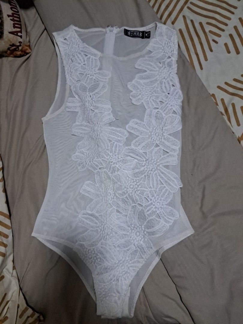White Lacey Floral Bodysuit (Category: Others Tops) located in Quezon City. Submitted by random-11731 (Listing ID 1432942395, Image 1). Description: - White bodysuit - Floral embroidery - Sheer mesh fabric - High neckline - Zipper closure - Thong back - Perfect for layering or as a statement piece.
