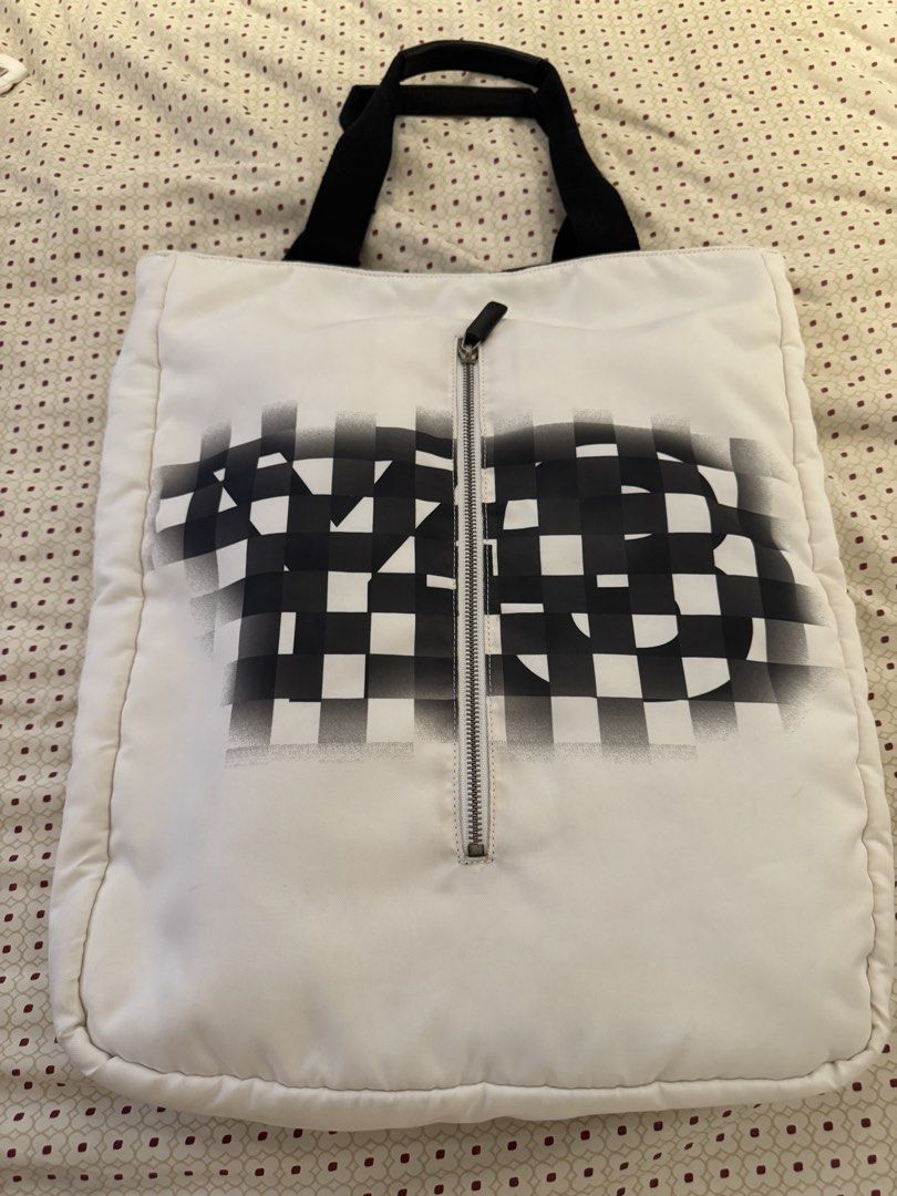 Y-3 Yohji Yamamoto Adidas Tote Bag (Category: Belt bags, Clutches and Pouches) located in Makati City. Submitted by marckyboy (Listing ID 1432973285, Image 1). Description: - Y-3 tote bag - Unique checkered design on the front - Zipper closure - Black handles - Spacious interior - Interior zippered pocket - Interior snap closure pocket - White with black accents - Y-3 and Adidas logos inside.