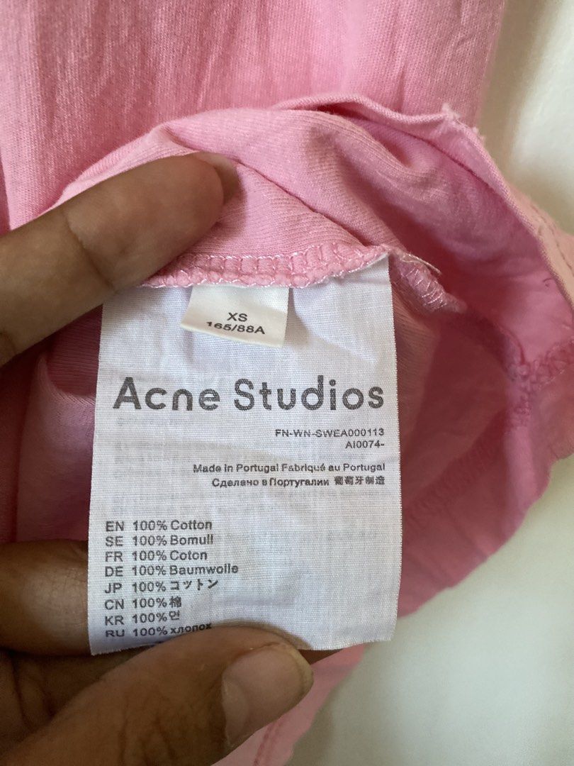 Acne Studios Stockholm 1996 Distress Pink T-shirt (Category: Luxury Apparel) located in Binmaley. Submitted by maryjeyn (Listing ID 1433033321, Image 2). Description: - Acne Studios T-shirt - Color: Pink - Print: "Acne Studios Stockholm 1996" - Size: XS - Made in Portugal - Material: 100% Cotton - Features: Crew neck, short sleeves and distress Tee.