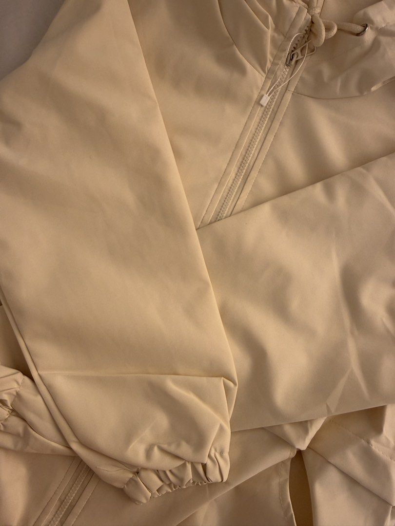 Alo Cream Jacket with Hood (Category: Coats, Jackets and Outerwear) located in Quezon City. Submitted by mochiringo84 (Listing ID 1433037378, Image 2). Description: - Cream-colored Alo jacket - Hooded with zipper closure - Features the Alo logo - Two side pockets - Elastic cuffs on sleeves - Made of lightweight material.