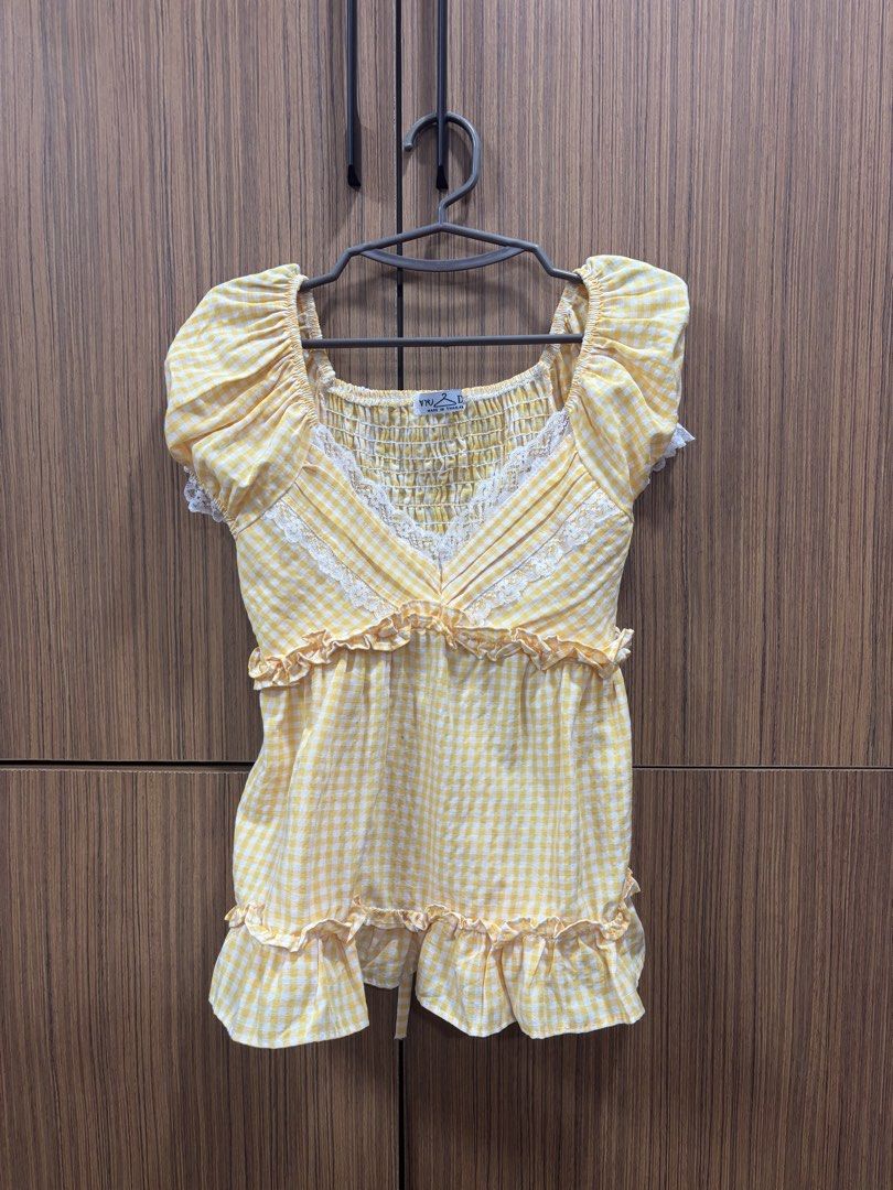 Bangkok Yellow Gingham Top with Lace (Category: Sleeveless) located in Manila. Submitted by inationg (Listing ID 1433117378, Image 2). Description: - Yellow gingham top - Square neckline - Delicate lace trim - Short, puffed sleeves - Ruffled hem - Lightweight fabric - Flattering fit - Ideal for casual outings or the beach.