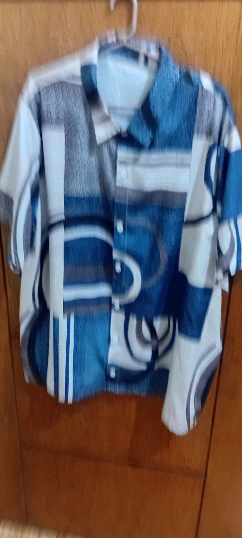 Blue Patterned Button-Down Shirt (Category: Tshirts & Polo Shirts ) located in Rizal. Submitted by yohan23 (Listing ID 1433207751, Image 2). Description: - Blue and white geometric pattern - Classic collar and buttoned cuffs - Lightweight fabric - Regular fit - Button-down front closure - Suitable for warmer weather.