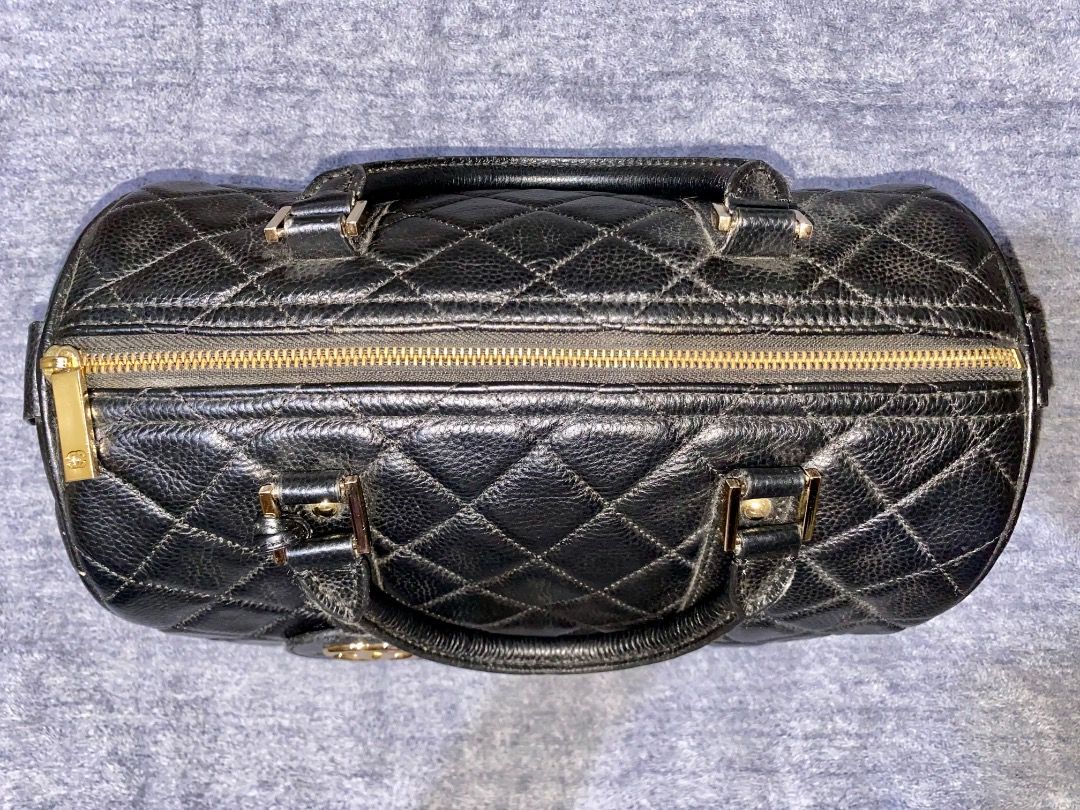 Chanel Quilted Leather Barrel Bag (Category: Luxury Bags & Wallets) located in Manila. Submitted by mcqueenskicks (Listing ID 1433083237, Image 2). Description: - Black quilted leather barrel bag - Gold-tone hardware - Top zipper closure - Dual top handles - Protective feet at base - Diamond pattern - Textured leather finish.