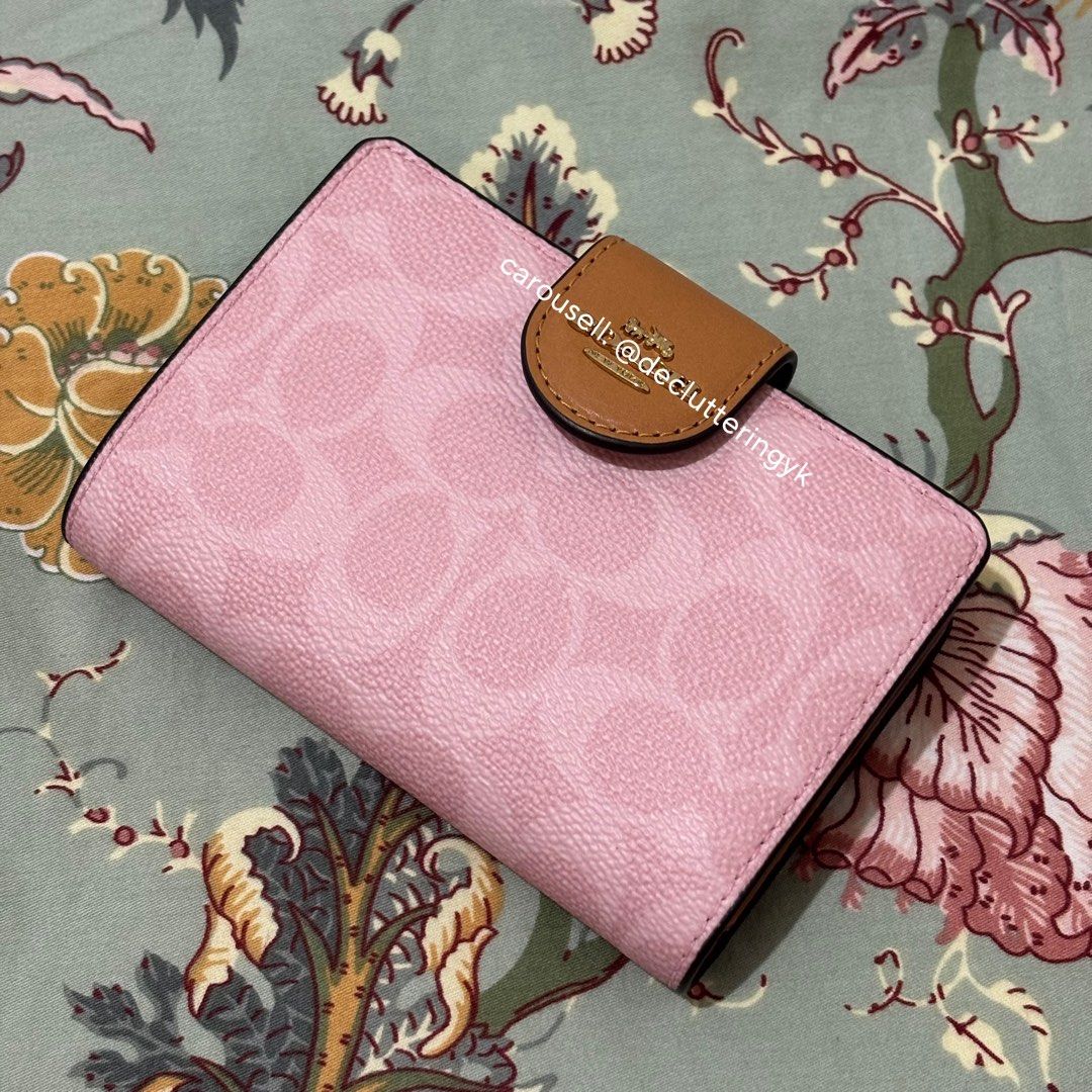 Coach Medium Corner Zip Wallet in Powder Pink (Category: Wallets & Card holders) located in Makati City. Submitted by declutteringyk (Listing ID 1433156241, Image 1). Description: BOUGHT FROM CANADA 🇨🇦 - Coach Medium Corner Zip Wallet - Color: Powder Pink - Features Coach logo pattern - Interior: Multiple card slots and bill compartment - Closure: Snap - Accent: Brown leather - Made in Myanmar.