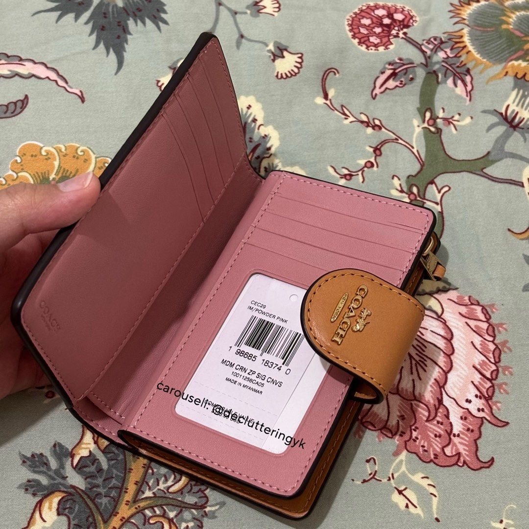 Coach Medium Corner Zip Wallet in Powder Pink (Category: Wallets & Card holders) located in Makati City. Submitted by declutteringyk (Listing ID 1433156241, Image 2). Description: BOUGHT FROM CANADA 🇨🇦 - Coach Medium Corner Zip Wallet - Color: Powder Pink - Features Coach logo pattern - Interior: Multiple card slots and bill compartment - Closure: Snap - Accent: Brown leather - Made in Myanmar.