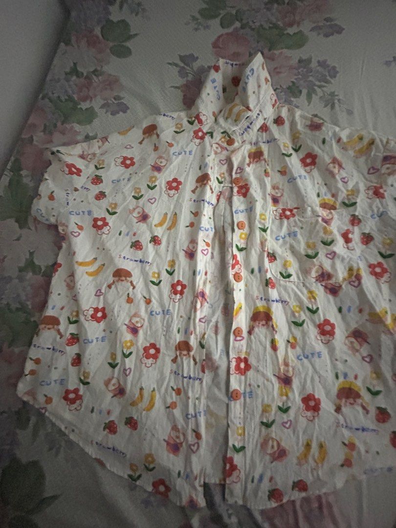 Colorful Strawberry Print Button-Up Shirt (Category: Shirts) located in Manila. Submitted by cheatea (Listing ID 1433181735, Image 2). Description: Cute button-up shirt with a fun strawberry and floral print. Features a collared neckline, chest pocket, and short sleeves. Relaxed fit, lightweight fabric. colorful polo worn once only, doing a closet cleanout.