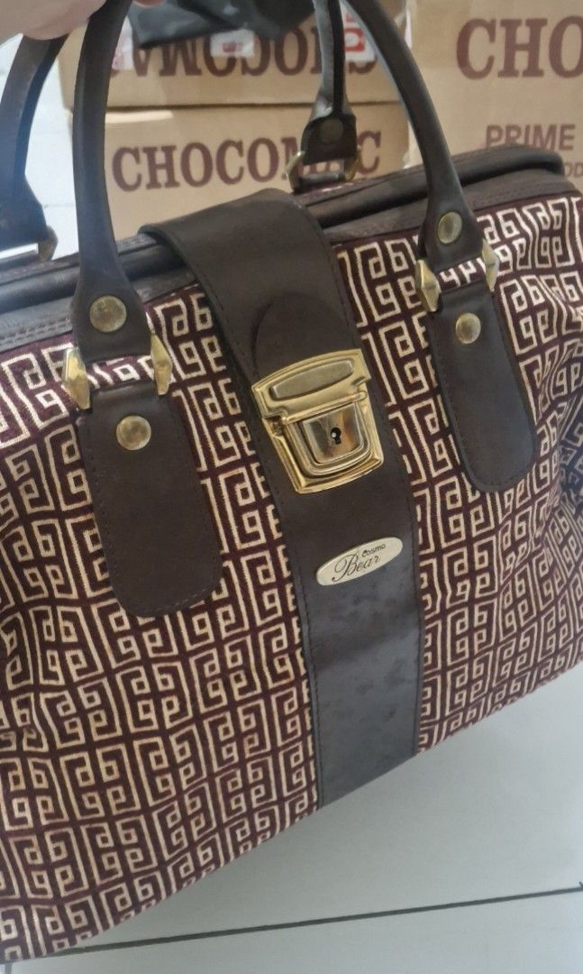 Cosmo Bear Pierre Balmain Handbag Japan (Category: Luxury Bags & Wallets) located in Manila. Submitted by youngcloud_b1fffa (Listing ID 1433190105, Image 1). Description: - Vintage Cosmo Bear handbag - Geometric pattern exterior - Gold-tone metallic frame - Signature lock closure - Light-colored interior lining - Interior pocket - Top handle - Brown strap with brand name "R&B Mix Japan Surplus Items".