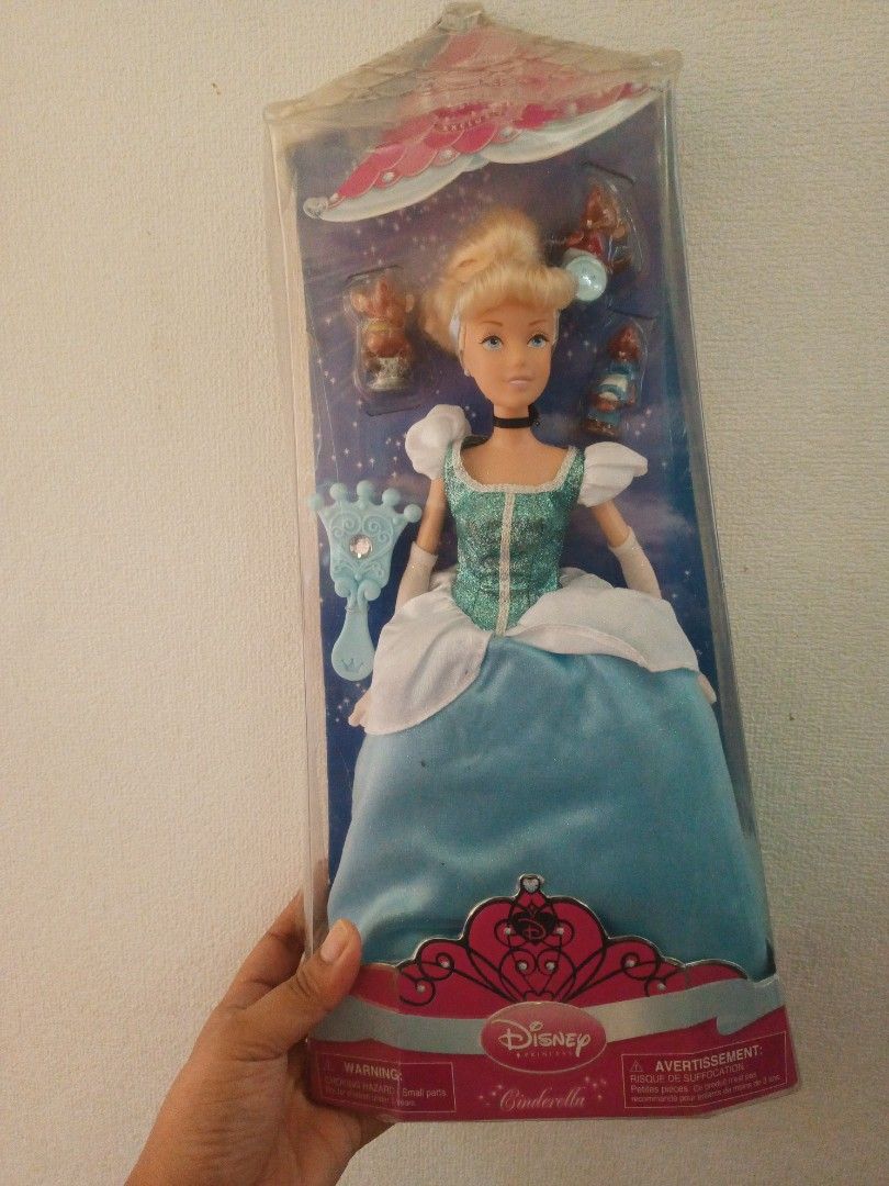 Disney Cinderella Doll (Category: Figurines & Statues) located in Naga. Submitted by cosmicrabbit.09254a (Listing ID 1433014680, Image 3). Description: - I can give a discount pag pay agad - Disney Cinderella doll - Brand new, in original packaging - Features a beautiful blue dress and blonde hair - the box has some dents, but the doll was never removed from the box - Includes accessories - Packaging showcases other Disney princesses - Back of pa