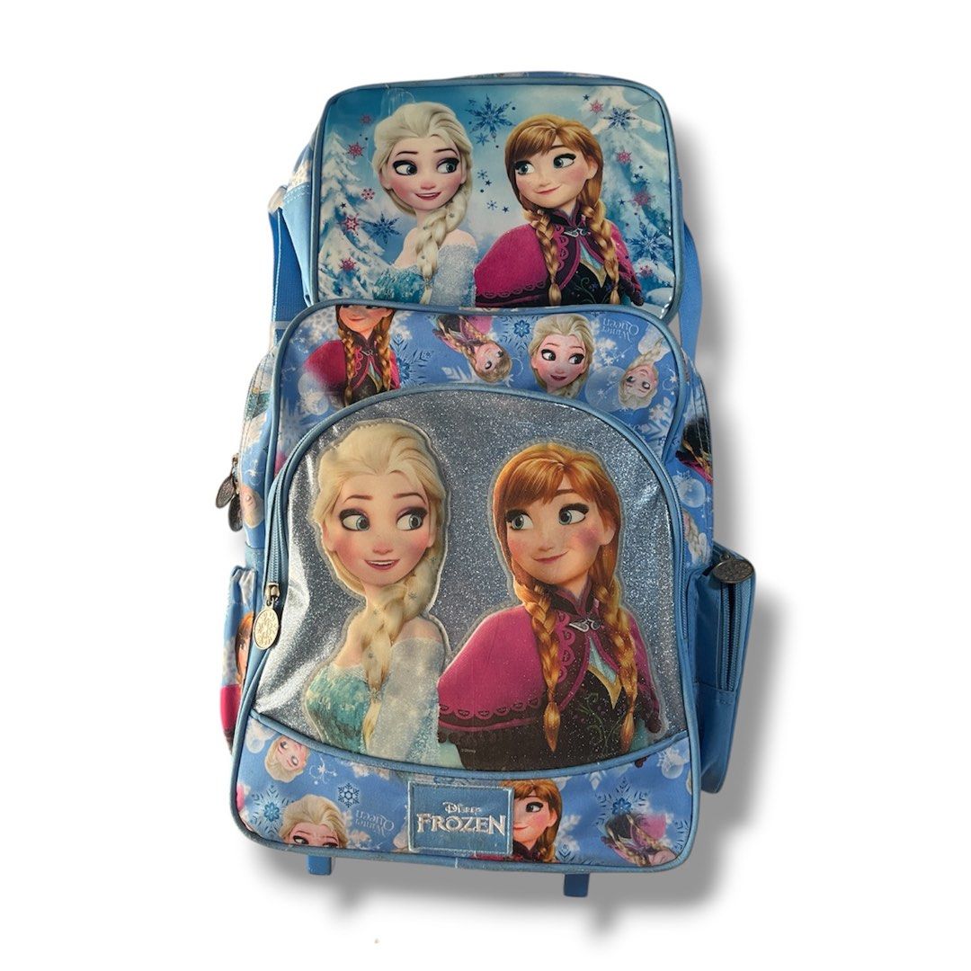 Disney Frozen Rolling Backpack (Category: Other Babies Going Out Needs) located in Manila. Submitted by jstash09 (Listing ID 1433068120, Image 1). Description: - Disney Frozen rolling backpack - Features Elsa and Anna - Blue color scheme - Multiple compartments for school supplies - Wheels and handle for easy carrying.