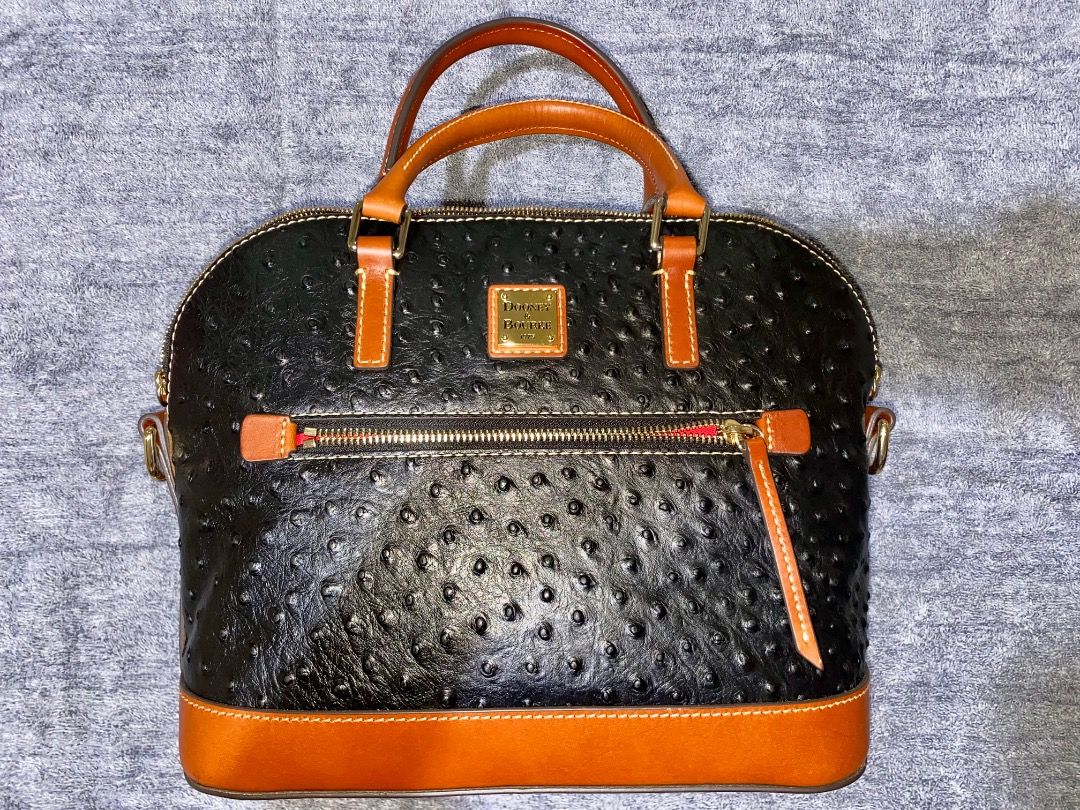 Dooney & Bourke Ostrich Zip Satchel (Category: Luxury Bags & Wallets) located in Manila. Submitted by mcqueenskicks (Listing ID 1433081560, Image 1). Description: Details: • Embossed premium calf leather. • Zipper closure. • Adjustable, detachable shoulder strap. • Strap drop length: 21". • Handle drop length: 5". • H 9.25" x D 5.25" x L 11.5" • Designed in Norwalk, CT by Peter Dooney. • Outside zip pocket. One inside zip pocket. Two inside pocke
