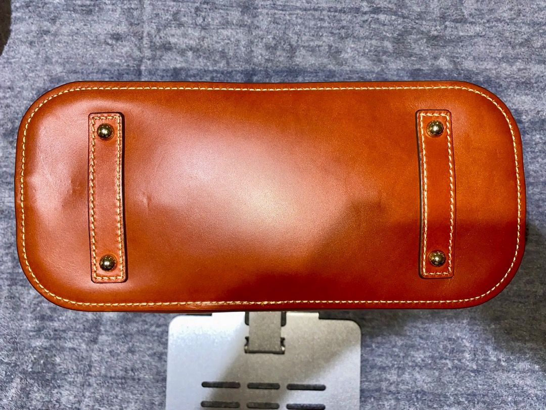 Dooney & Bourke Ostrich Zip Satchel (Category: Luxury Bags & Wallets) located in Manila. Submitted by mcqueenskicks (Listing ID 1433081560, Image 2). Description: Details: • Embossed premium calf leather. • Zipper closure. • Adjustable, detachable shoulder strap. • Strap drop length: 21". • Handle drop length: 5". • H 9.25" x D 5.25" x L 11.5" • Designed in Norwalk, CT by Peter Dooney. • Outside zip pocket. One inside zip pocket. Two inside pocke