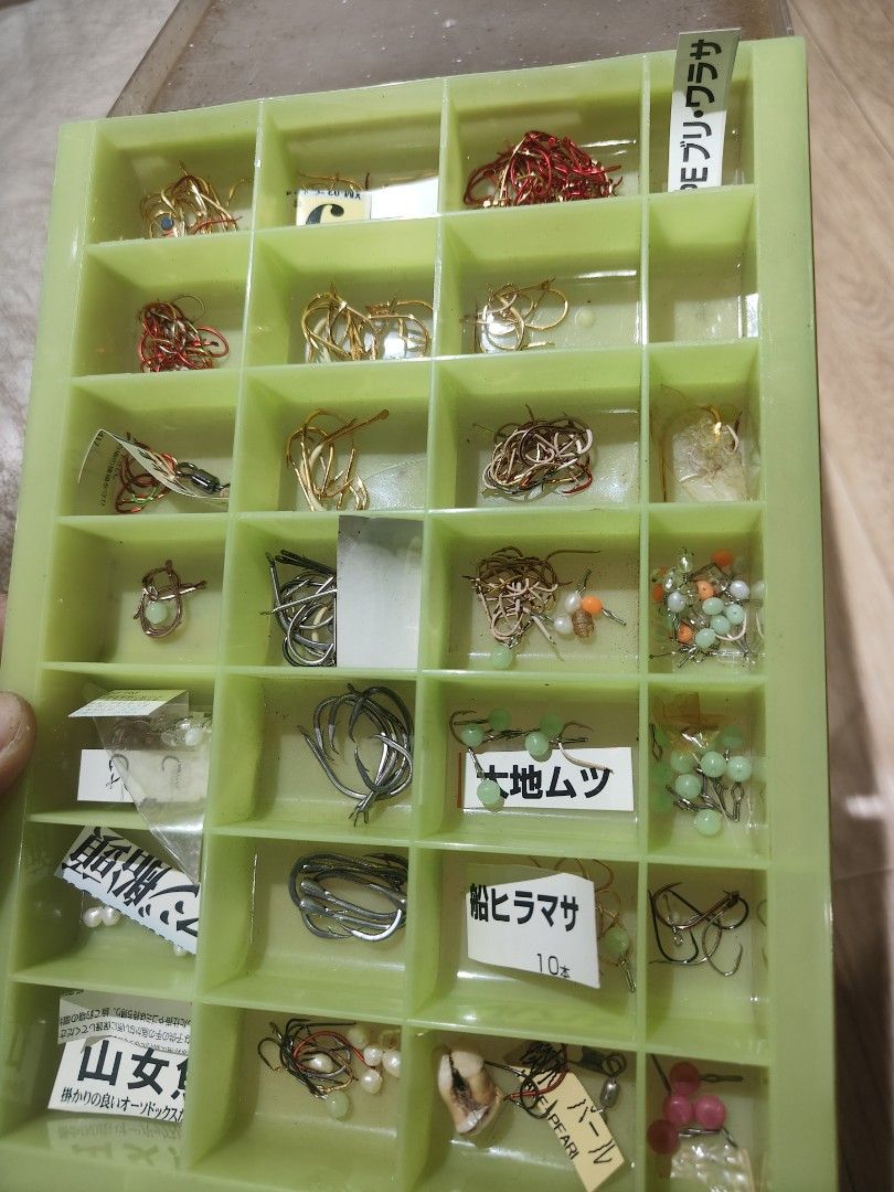 Fishing Lure Assortment (Category: Fishing) located in Cavite. Submitted by sevillajoh71978 (Listing ID 1433050485, Image 1). Description: - Fishing lure collection in a green organizer. - Includes various hooks and lures. - Features lures with beads and Japanese labels. - Designed for different fishing techniques. - Suitable for various fish species. - Perfect for anglers looking to upgrade their tackle box..