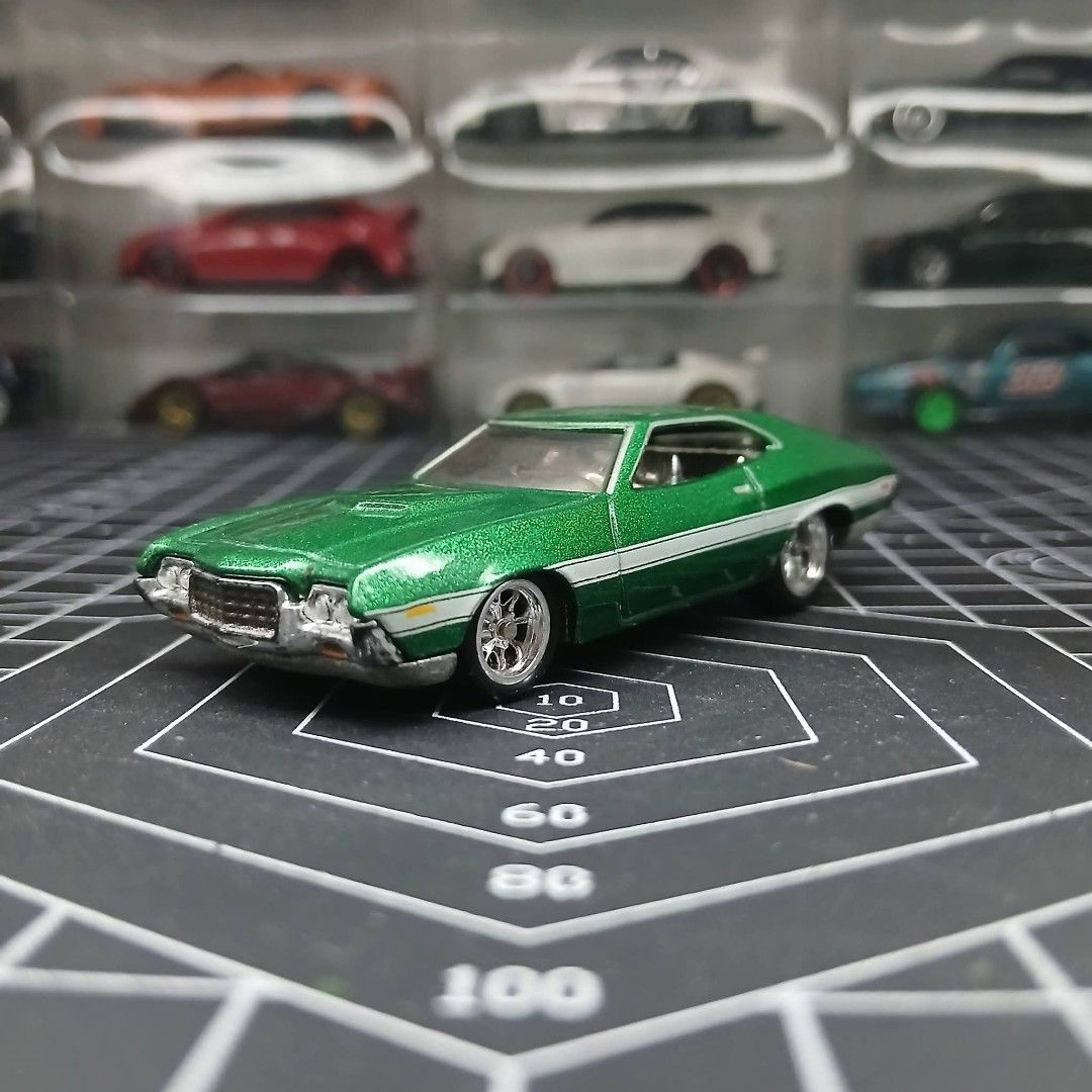 Ford Torino Hot Wheels Premium (Category: Vehicle & Diecast Models) located in Tanauan. Submitted by jeuskingz (Listing ID 1433187524, Image 1). Description: - Green Ford Torino diecast model - Detailed exterior - White stripe detail - Custom wheels - Lowered suspension - Displayed on a black cutting mat - Collectible - Mint.