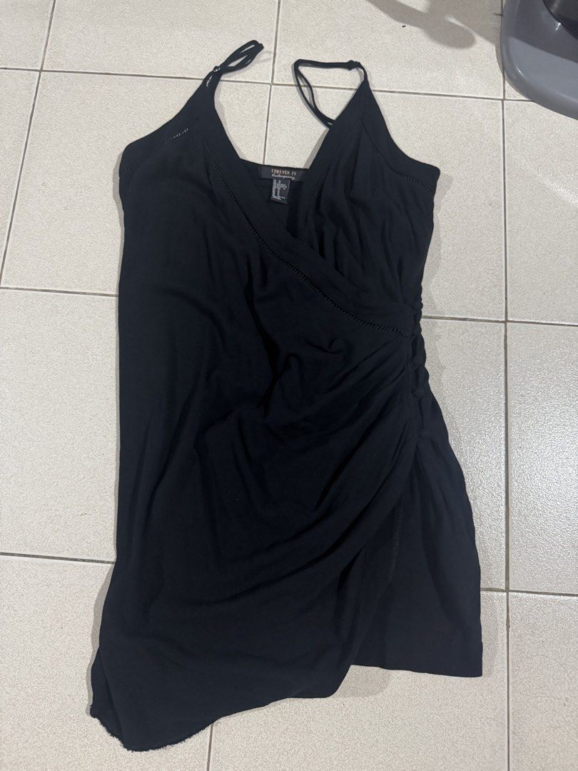 Forever 21 Black Wrap Dress (Category: Dresses) located in Manila. Submitted by hackelina (Listing ID 1433096455, Image 2). Description: - Forever 21 black wrap dress - Size: M - Features a flattering wrap design - V-neckline with delicate straps - Ruched detail with button accents - Made from lightweight fabric.