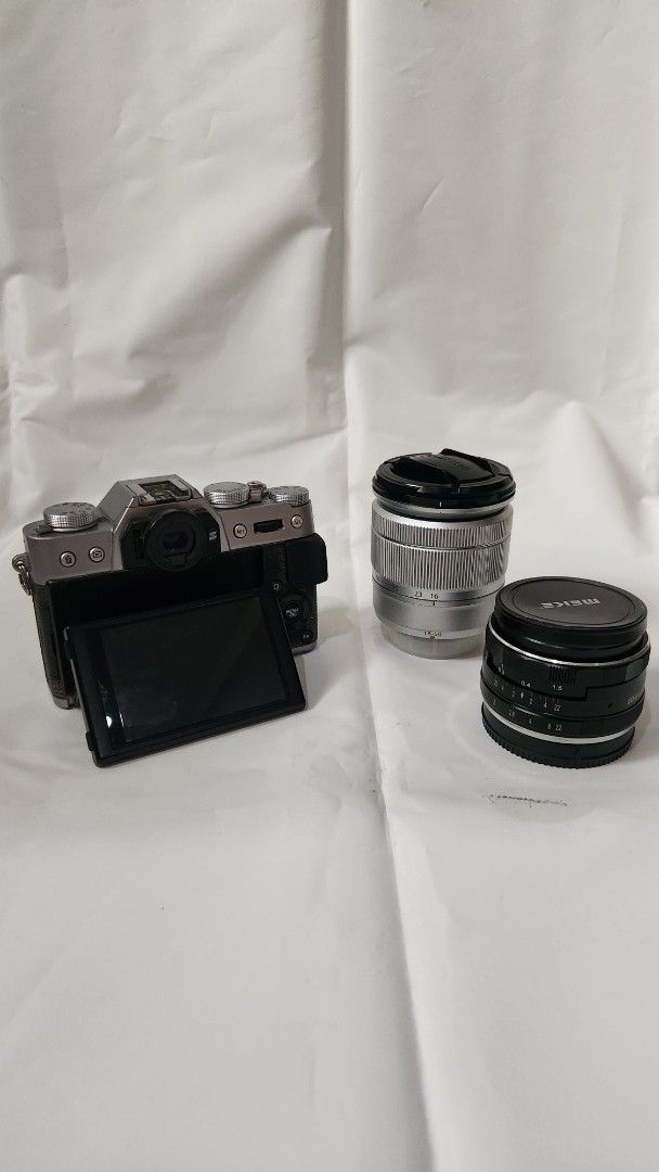 Fujifilm X-T10 Camera with Lenses (Category: Cameras) located in Antipolo. Submitted by luislasi (Listing ID 1433148589, Image 2). Description: - Fujifilm X-T10 camera body - Two lenses: = 16-50mm zoom lens (silver) = and 35mm prime lens (black) (thrid party) - Three batteries - Two Battery charger (one third party) - Camera strap - Hand grip (third party small rig) - Lens cap - Small tool - Original box - Features a flip-out screen and manual di