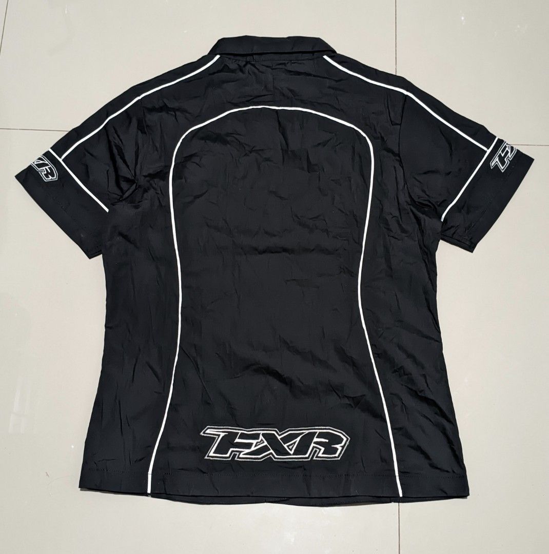 FXR Short Sleeve Shirt (Category: Blouses) located in Caloocan City. Submitted by wupeeram (Listing ID 1433135639, Image 2). Description: - Black short sleeve shirt - White FXR logo and accents - Collared neckline - Button-up front - FXR logo on front, back, and sleeves - Size: L26, W18, W20 - Brand new condition - Made in China.