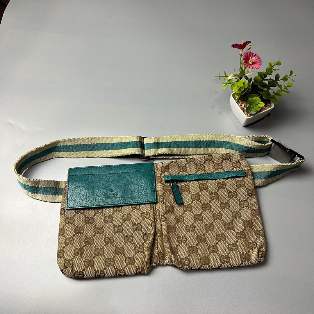 Gucci GG Canvas Waist Bag (Category: Luxury Bags & Wallets) located in Bago City. Submitted by g___shop (Listing ID 1433127288, Image 1). Description: - Authentic Gucci waist bag - Iconic GG canvas - Teal leather card holder and accents - Main compartment and front pocket - Adjustable strap with silver buckle - Made in Italy - Rank A.