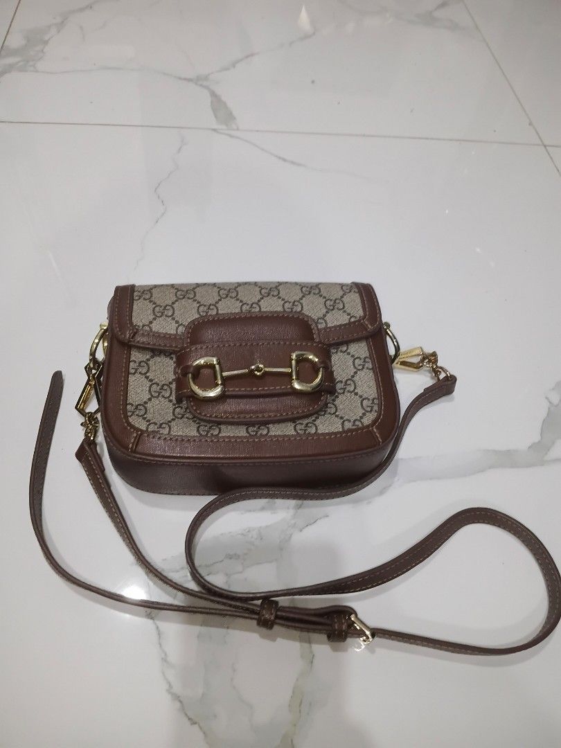 Gucci Horsebit 1955 Mini Bag (Category: Luxury Bags & Wallets) located in Manila. Submitted by daisuki8 (Listing ID 1433082886, Image 2). Description: - Authentic Gucci Horsebit 1955 Mini Bag - Brown leather trim - Gold-toned Horsebit detail - Detachable shoulder strap - Spacious interior with light-colored fabric lining - Flap closure - Gold-toned hardware.