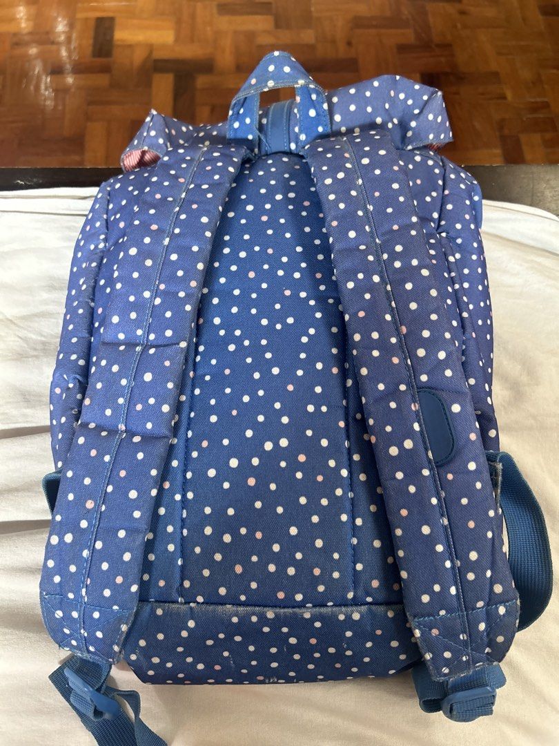 Herschel Backpack Blue Polka Dots (Category: Backpacks) located in Marikina City. Submitted by decluttering522 (Listing ID 1433035234, Image 2). Description: - Herschel backpack with a fun blue polka dot design. - Secure drawstring and buckle closure. - Stylish red and white striped interior. - Comfortable padded shoulder straps and a top handle. - Wear and tear on corners and bottom, reflecting its use..