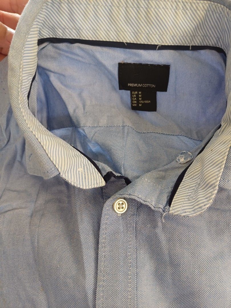 H&M Premium Cotton Shirt - Blue (Category: Shirts) located in Calasiao. Submitted by mamadang (Listing ID 1433040273, Image 3). Description: - H&M Premium Cotton Shirt - Light blue color - Size M - Button-down style - Collared neckline - Long sleeves - Made of 100% cotton - Versatile and classic design.